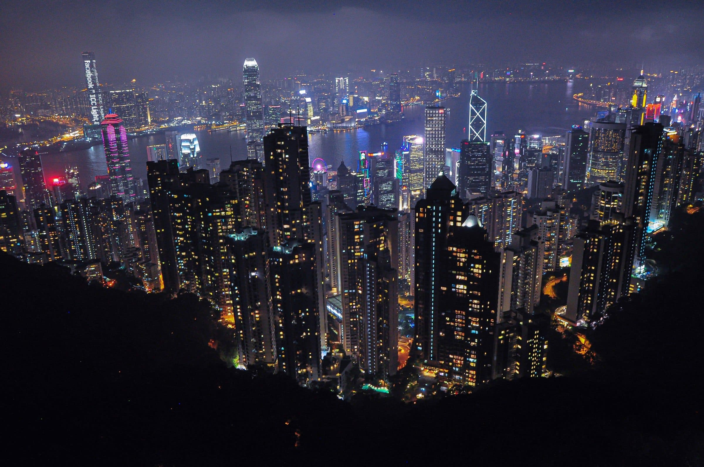 Dense high-rise skyline seen from a hilltop at night
