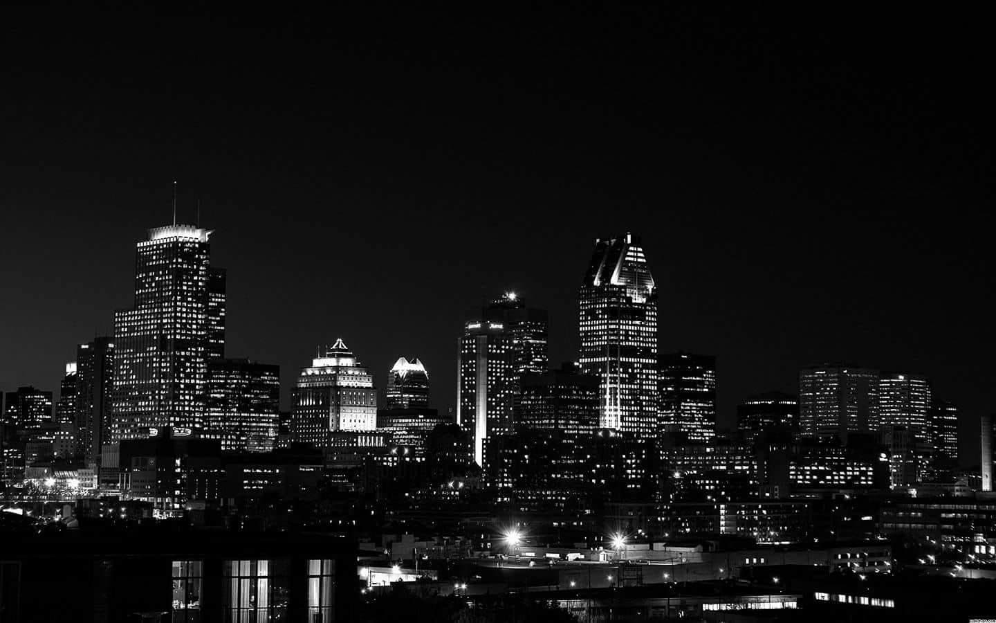 City skyline at night reflected in dark water, in black and white