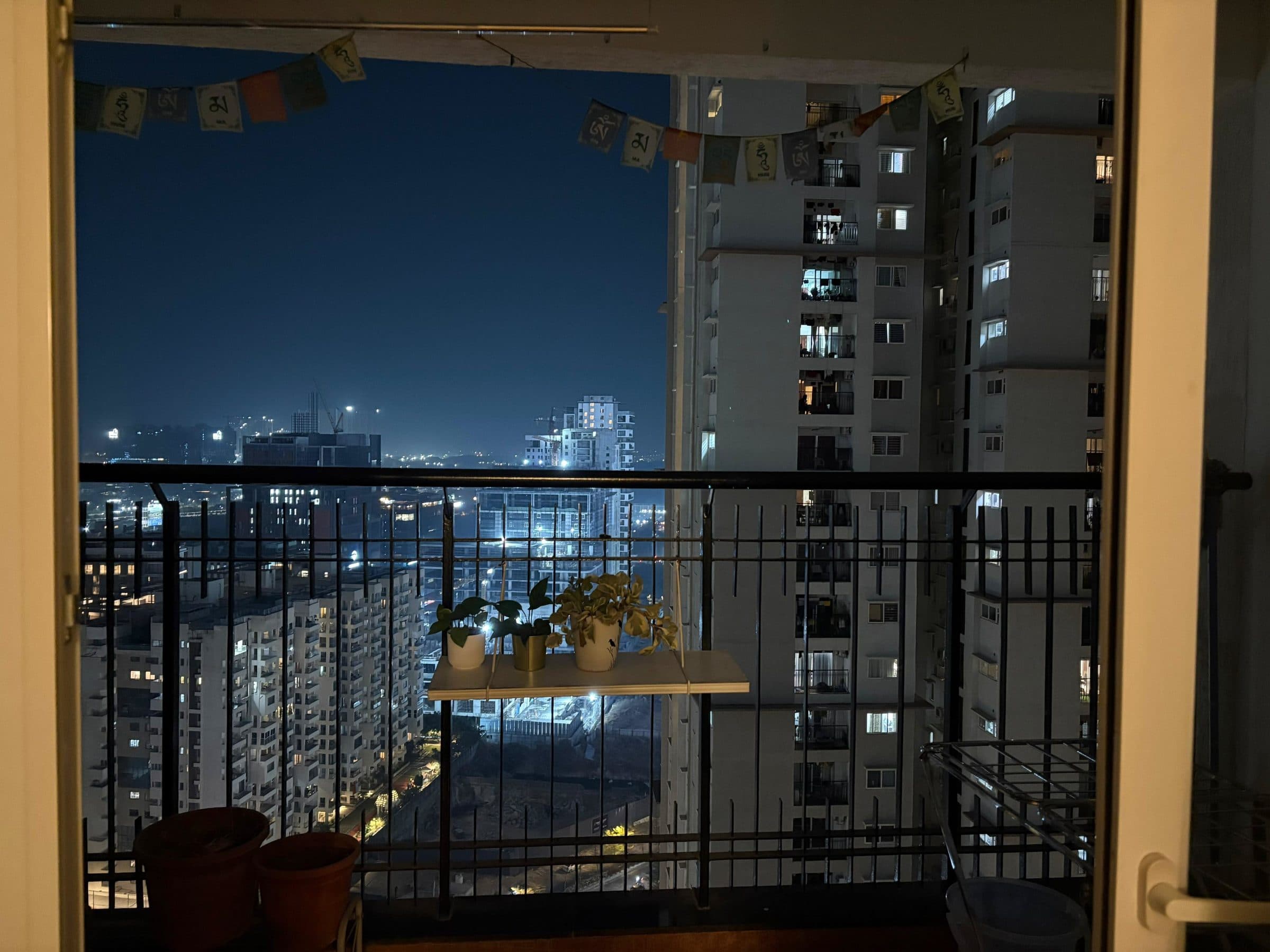 Rows of lit apartment windows on a curved tower at night