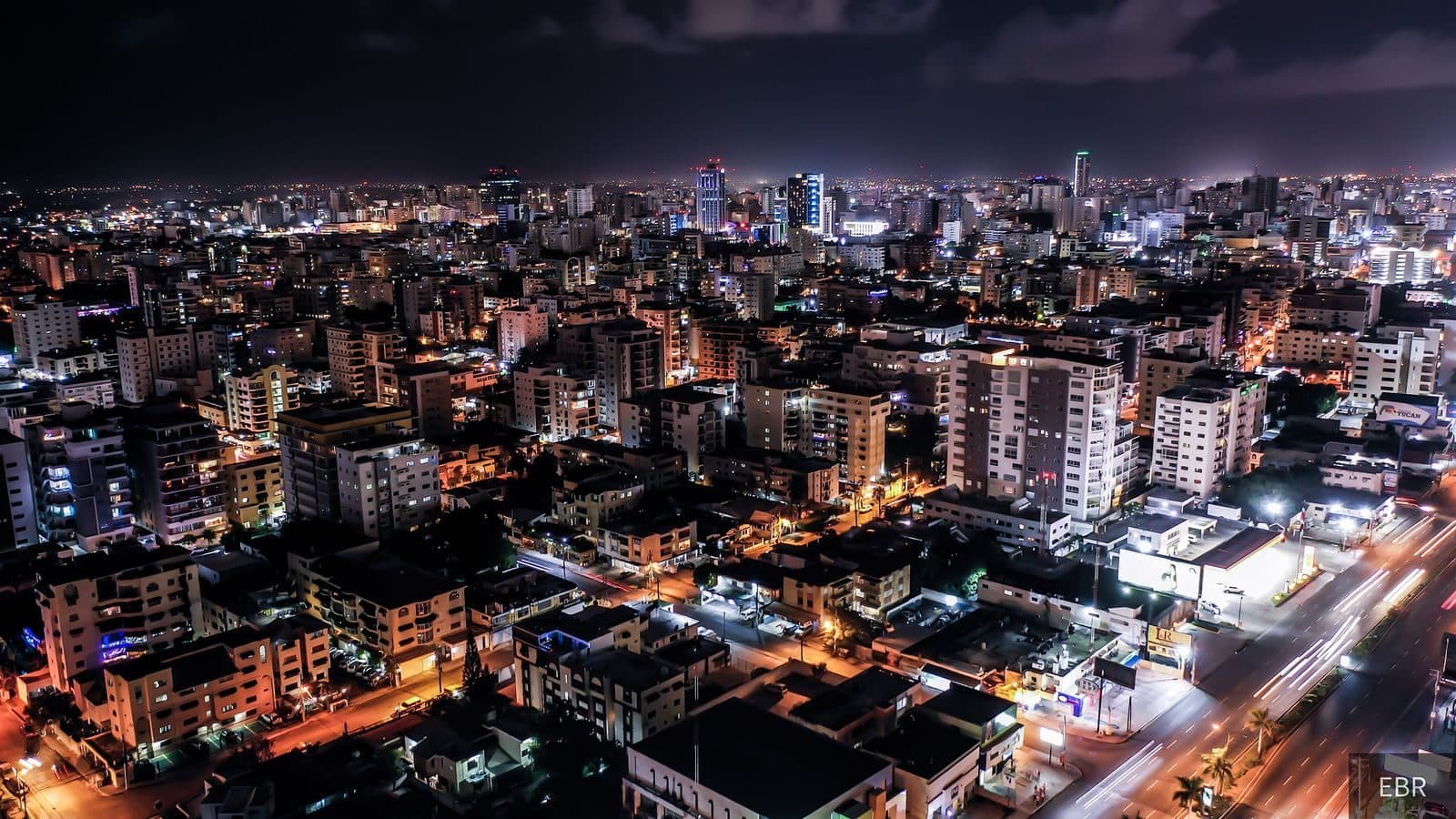 Santo Domingo at night seen from above, streets lit in orange