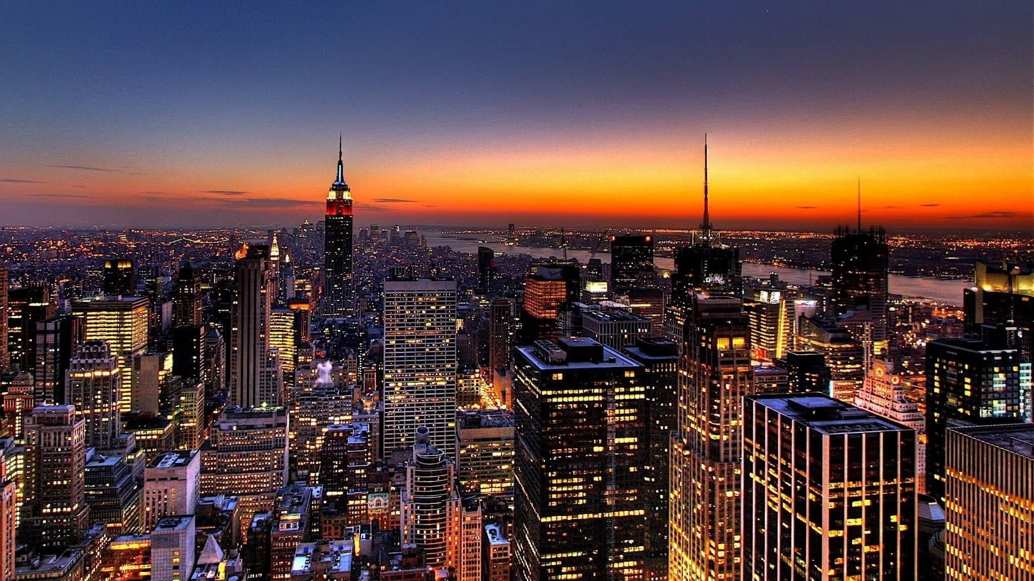 Manhattan skyline at dusk with the Empire State Building lit