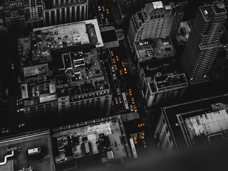 Black-and-white aerial view of dense city rooftops