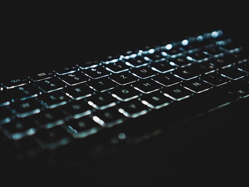 Close-up of a black keyboard on a dark desk