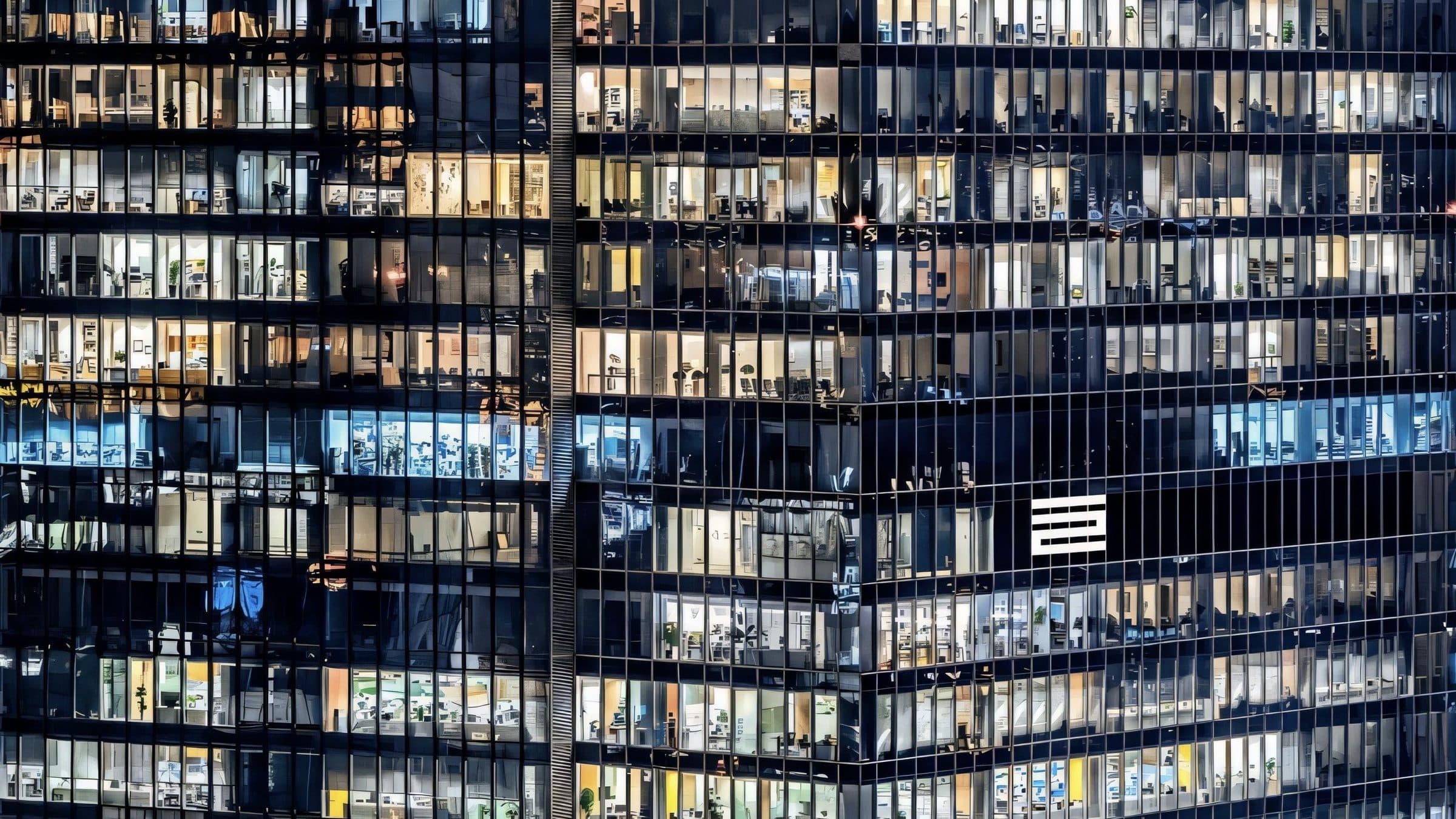 Dense grid of lit office windows at night
