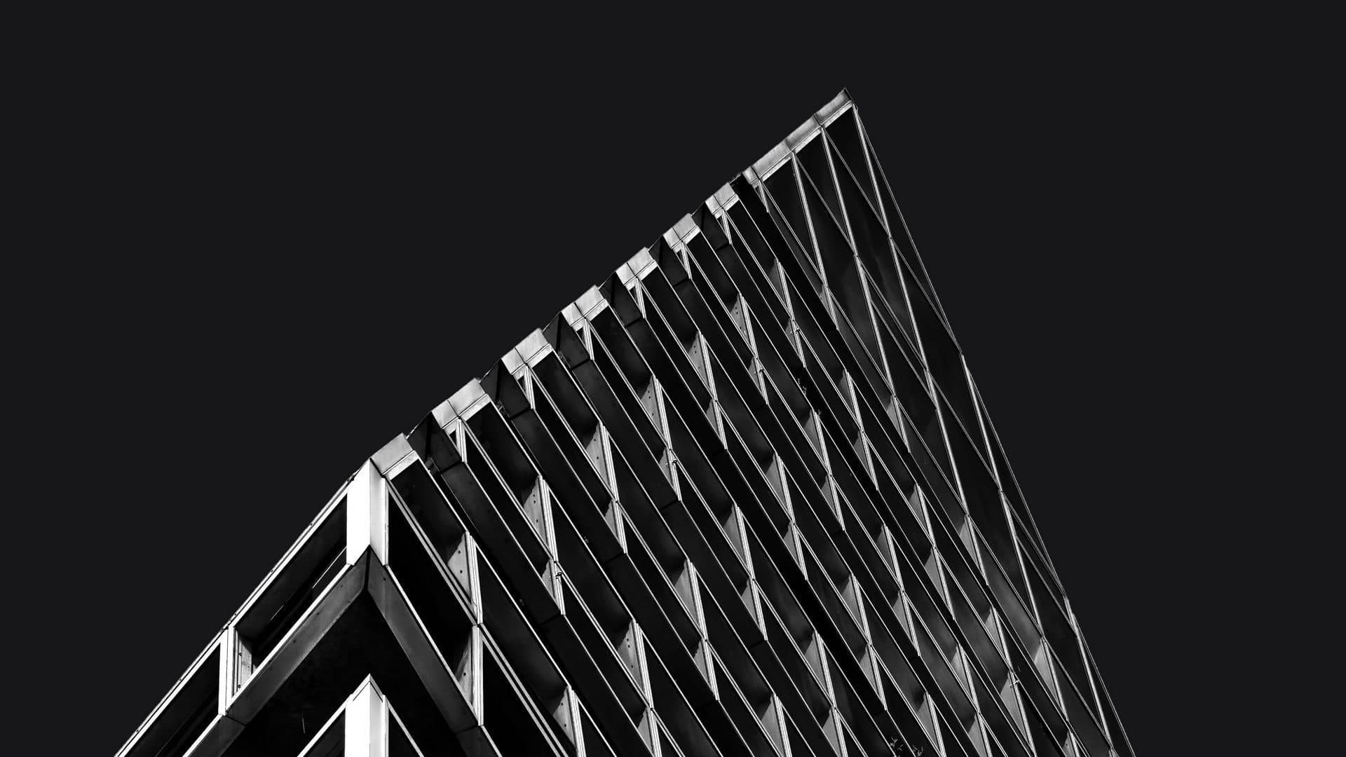 Black and white close-up of a building facade divided into identical units