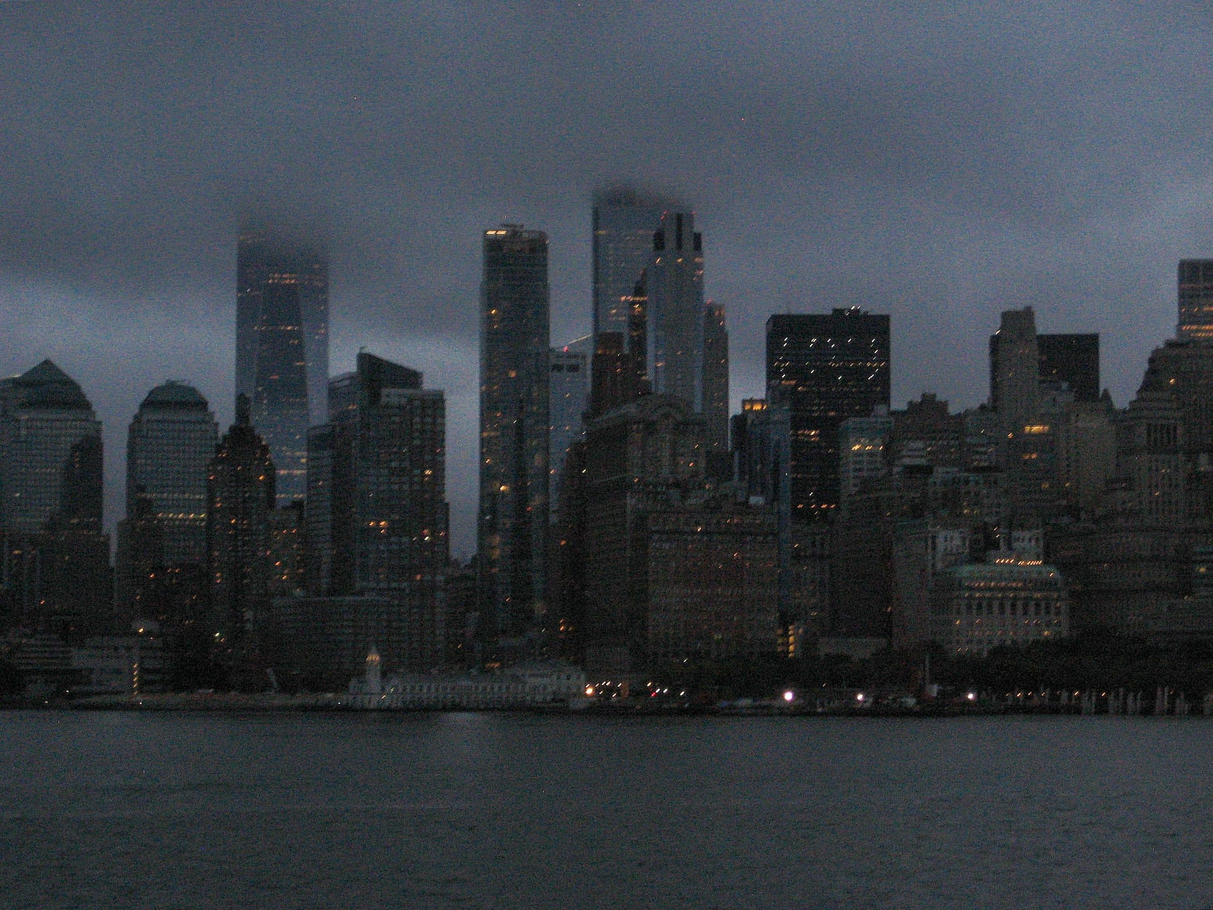 City skyline of towers under a dark overcast sky