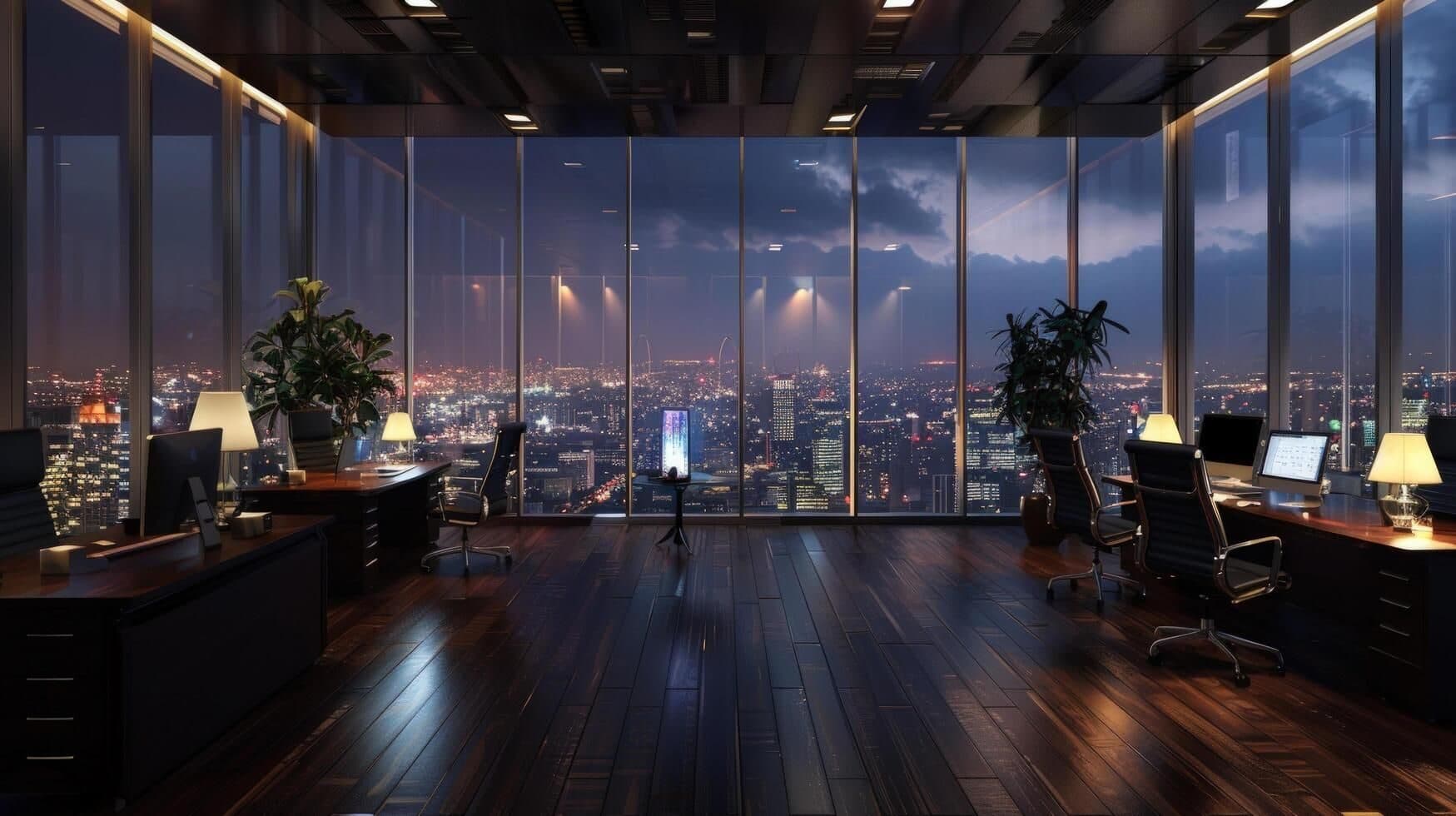 Office floor at night looking out over a city through glass