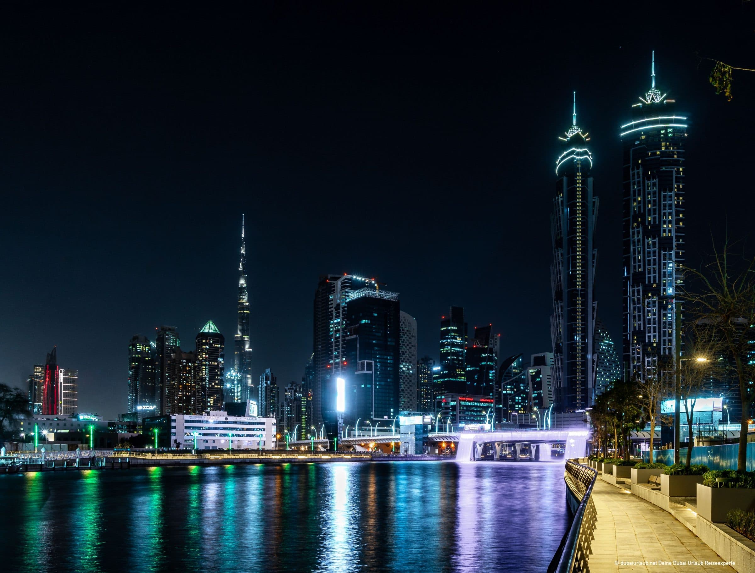 Dubai skyline at night with the Burj Khalifa lit against a dark sky